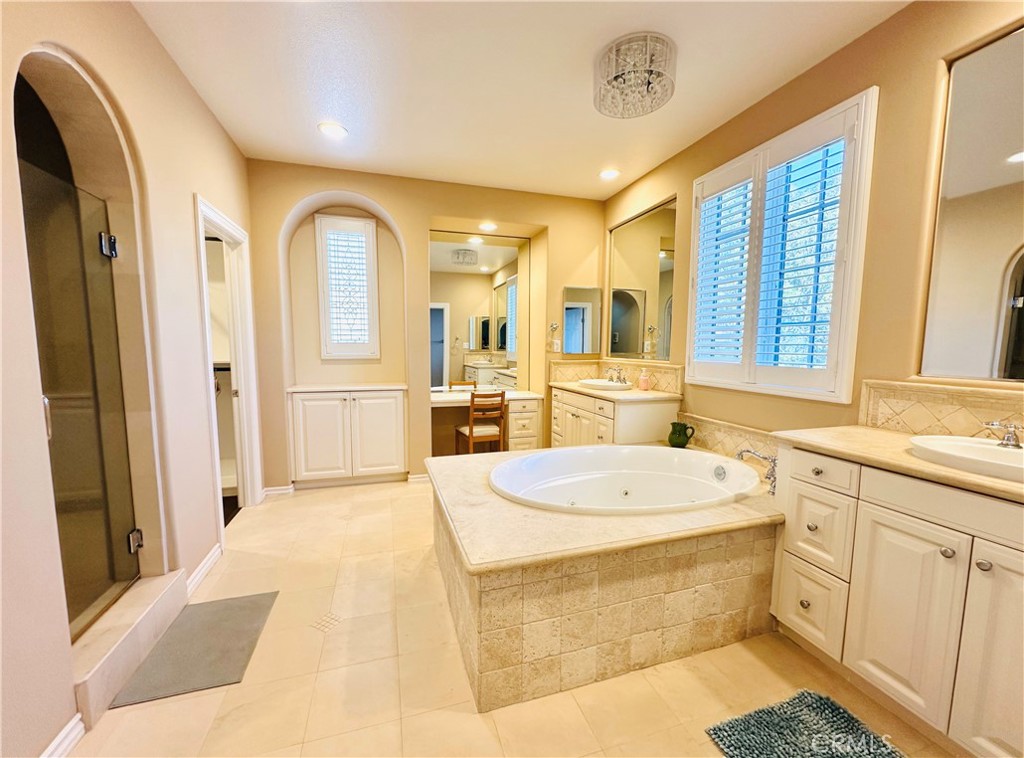 24 Silhouette Irvine, CA 92603 - Photo 17 of 36 a large bathroom with a tub sink and mirror