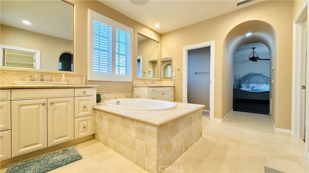 24 Silhouette Irvine, CA 92603 - Photo 18 of 36 a spacious bathroom with a sink a mirror and a shower