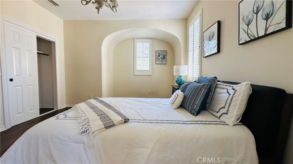 24 Silhouette Irvine, CA 92603 - Photo 25 of 36 a bedroom with a bed and painting on the wall