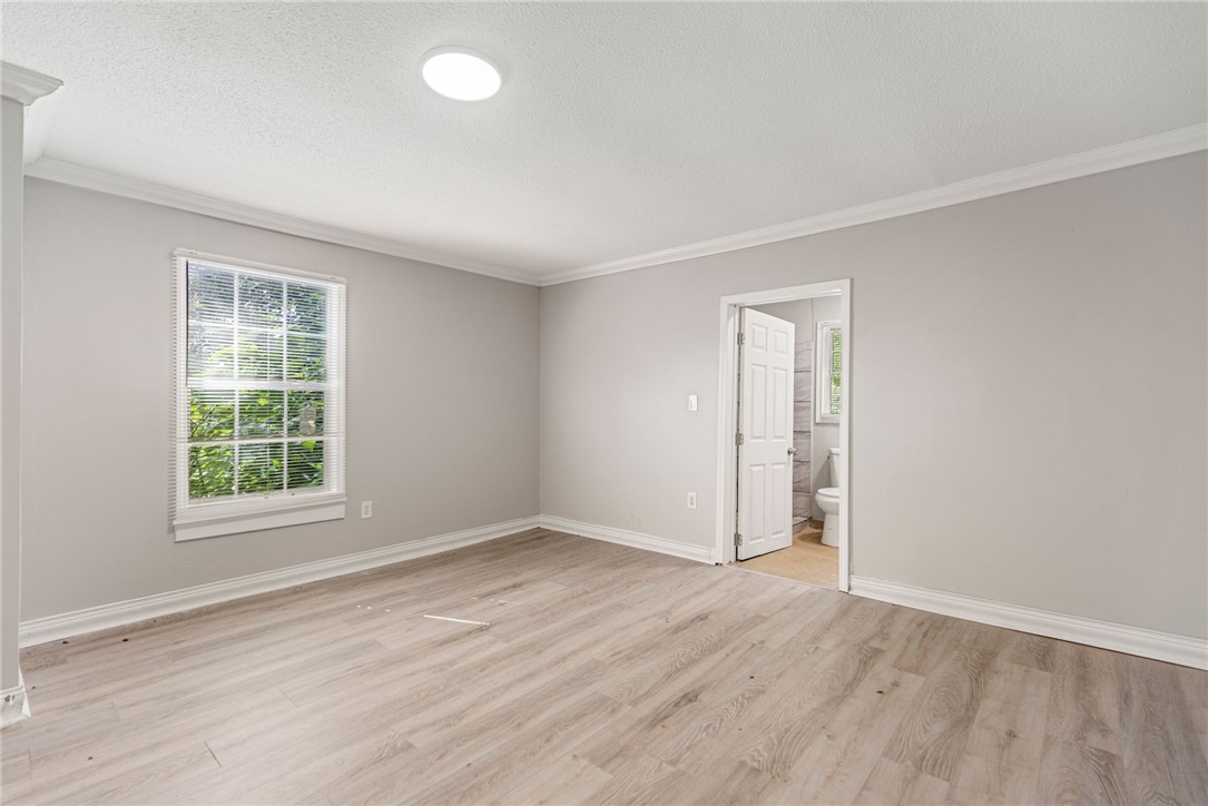 109 Farmer Street Anderson, SC 29621 - Photo 22 of 31 A well-lit bedroom with light-toned laminate flooring offers a tranquil retreat with convenient bathroom access.