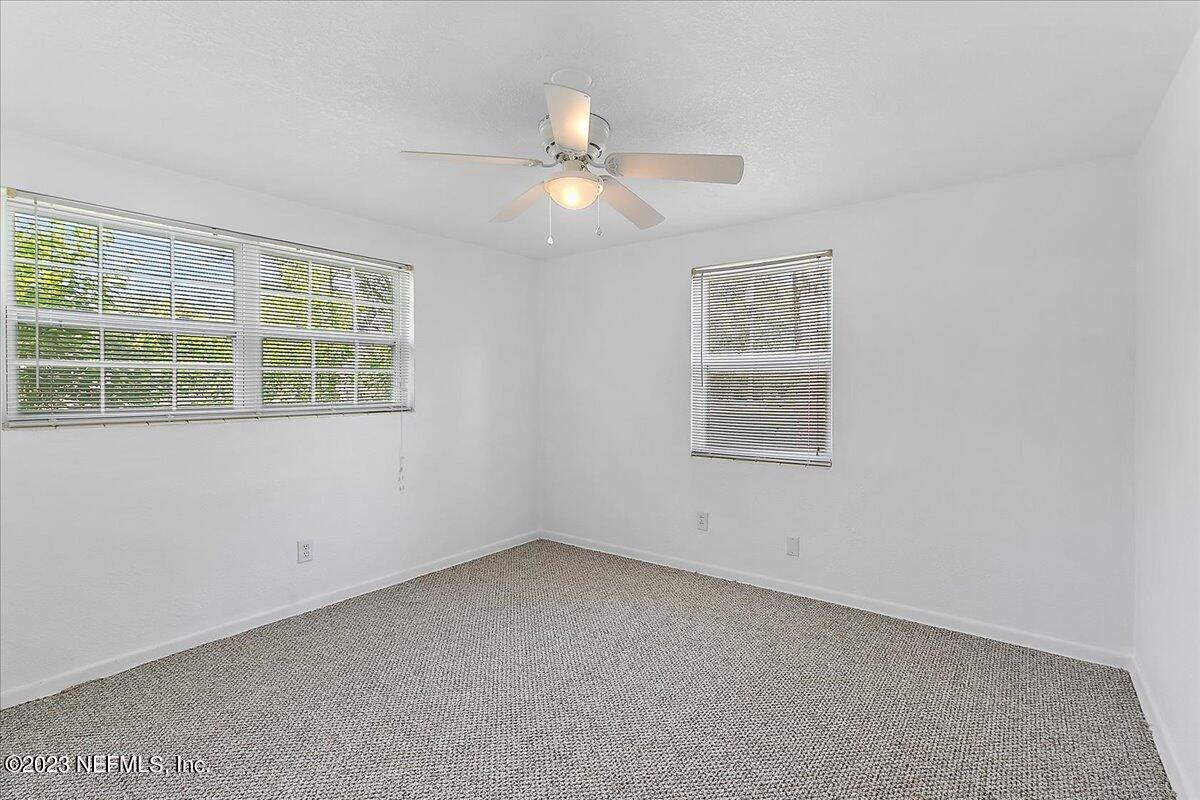 8543 Synhoff Drive Jacksonville, FL 32216 - Photo 11 of 19 an empty room with a window and a fan