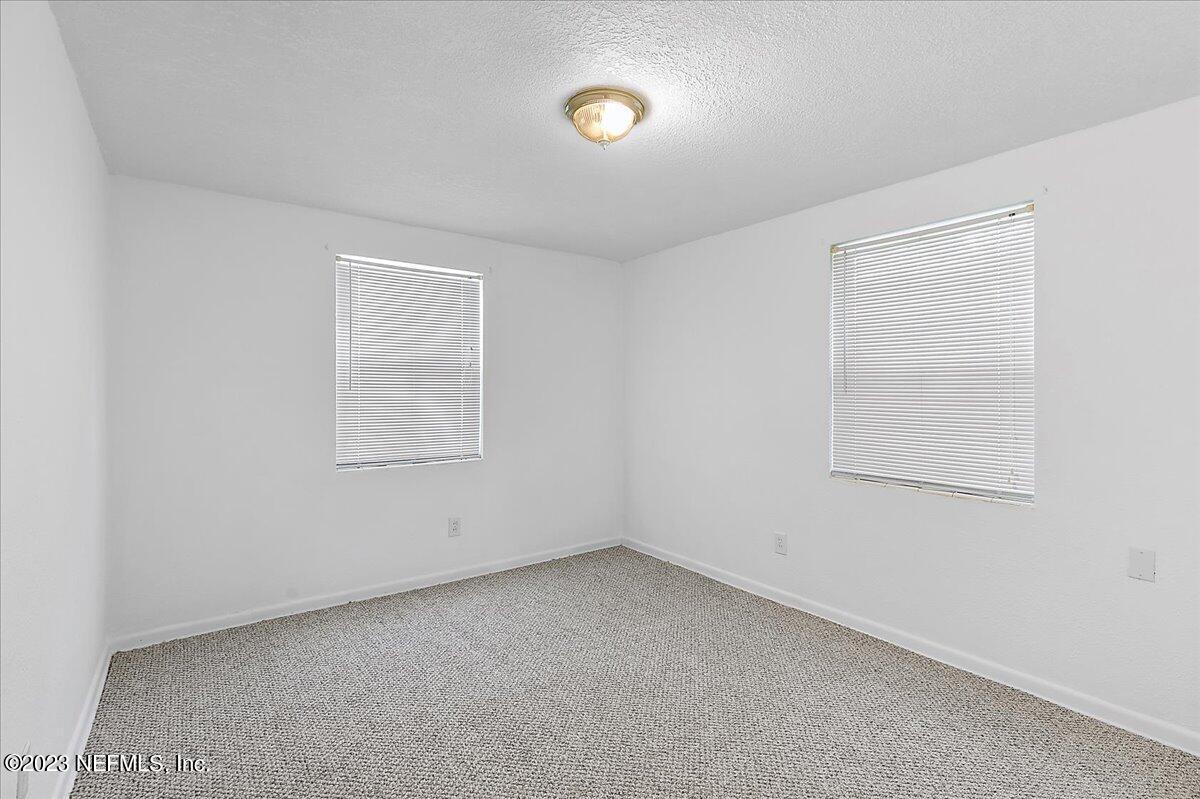 8543 Synhoff Drive Jacksonville, FL 32216 - Photo 12 of 19 an empty room with a window