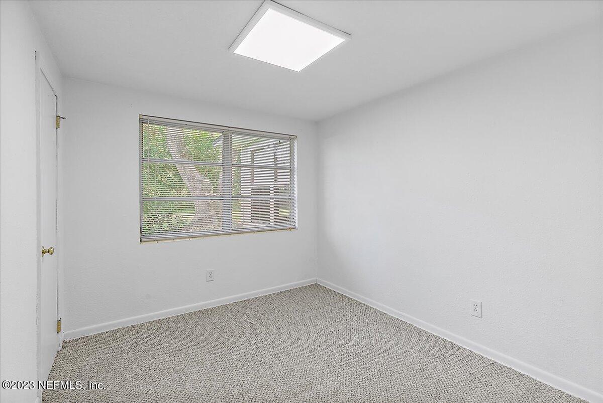 8543 Synhoff Drive Jacksonville, FL 32216 - Photo 13 of 19 an empty room with windows