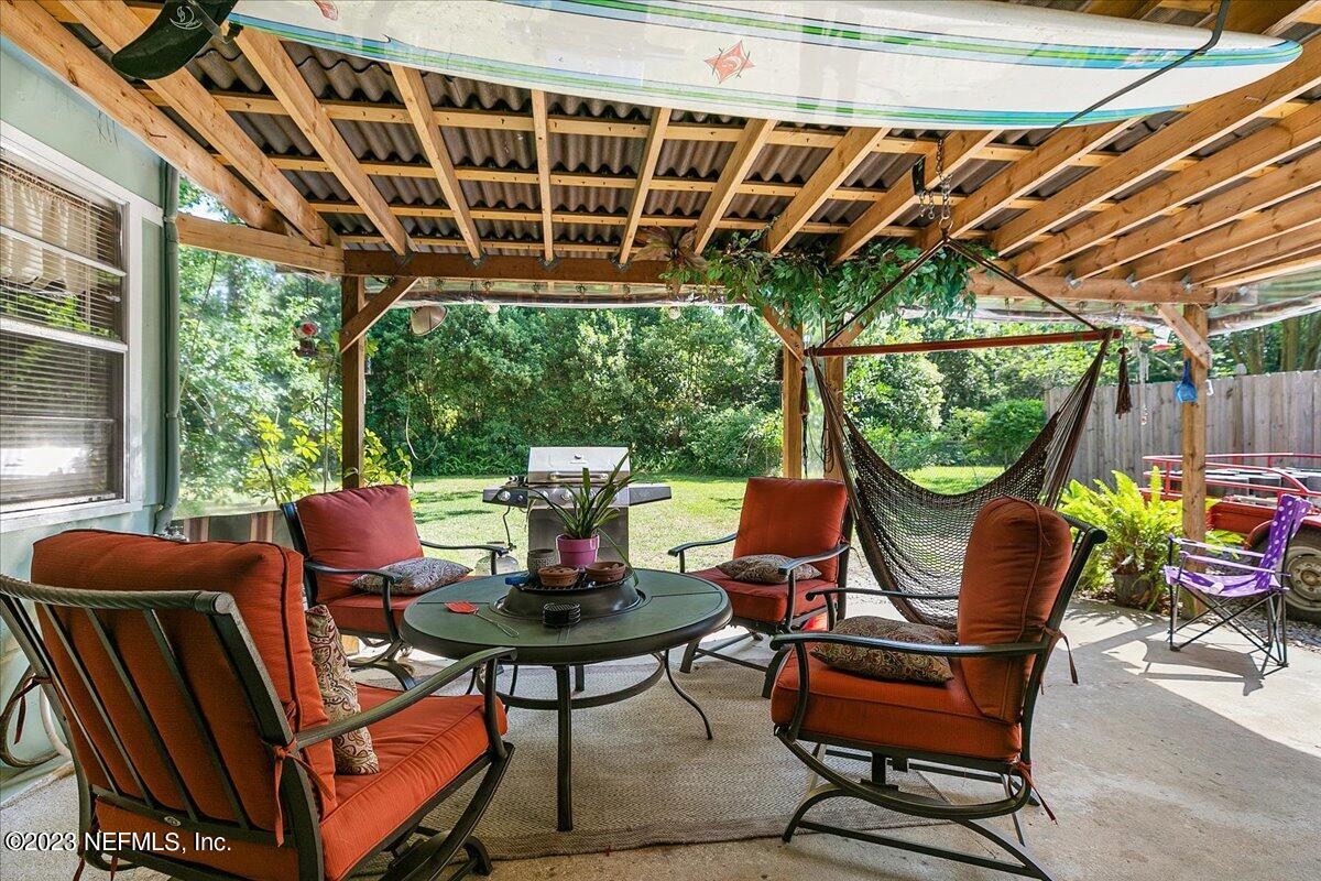 8543 Synhoff Drive Jacksonville, FL 32216 - Photo 15 of 19 a view of a patio with table and chairs and potted plants