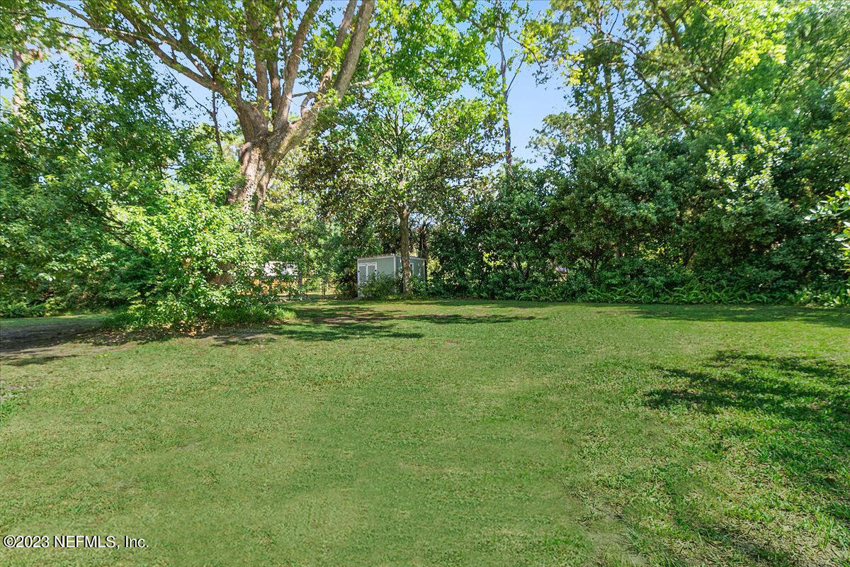 8543 Synhoff Drive Jacksonville, FL 32216 - Photo 17 of 19 a view of outdoor space with deck and yard