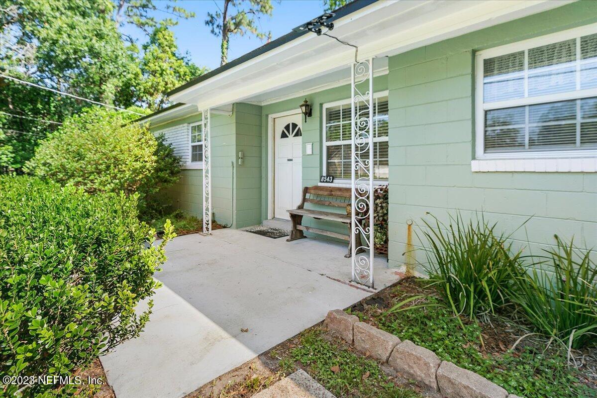 8543 Synhoff Drive Jacksonville, FL 32216 - Photo 2 of 19 a backyard of a house with table and chairs and potted plants