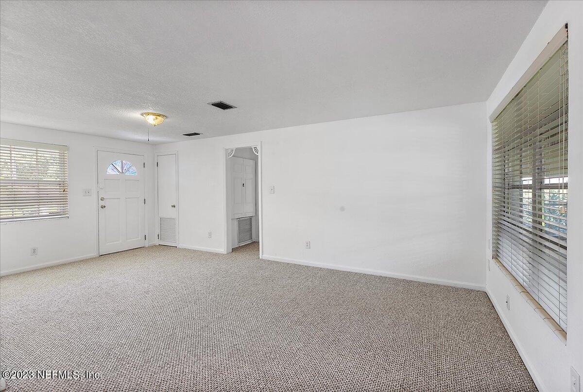 8543 Synhoff Drive Jacksonville, FL 32216 - Photo 5 of 19 an empty room with windows