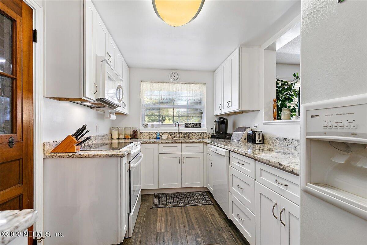 8543 Synhoff Drive Jacksonville, FL 32216 - Photo 8 of 19 a kitchen with a sink a stove and cabinets