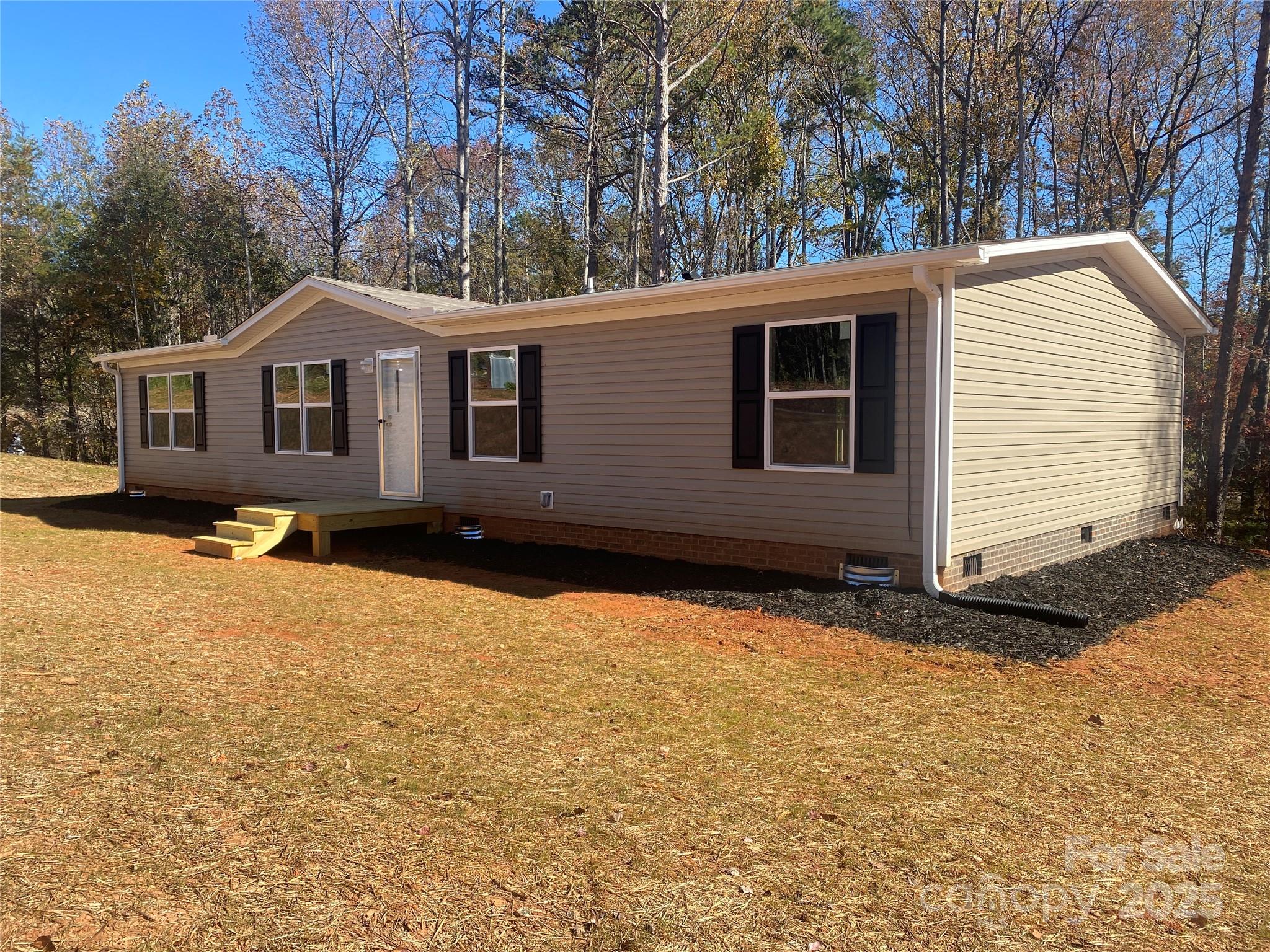 660 Pinehurst Road Ellenboro, NC 28040 - Photo 1 of 29 a house with trees in the background