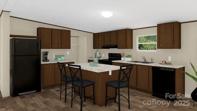 a kitchen with a refrigerator and a stove top oven