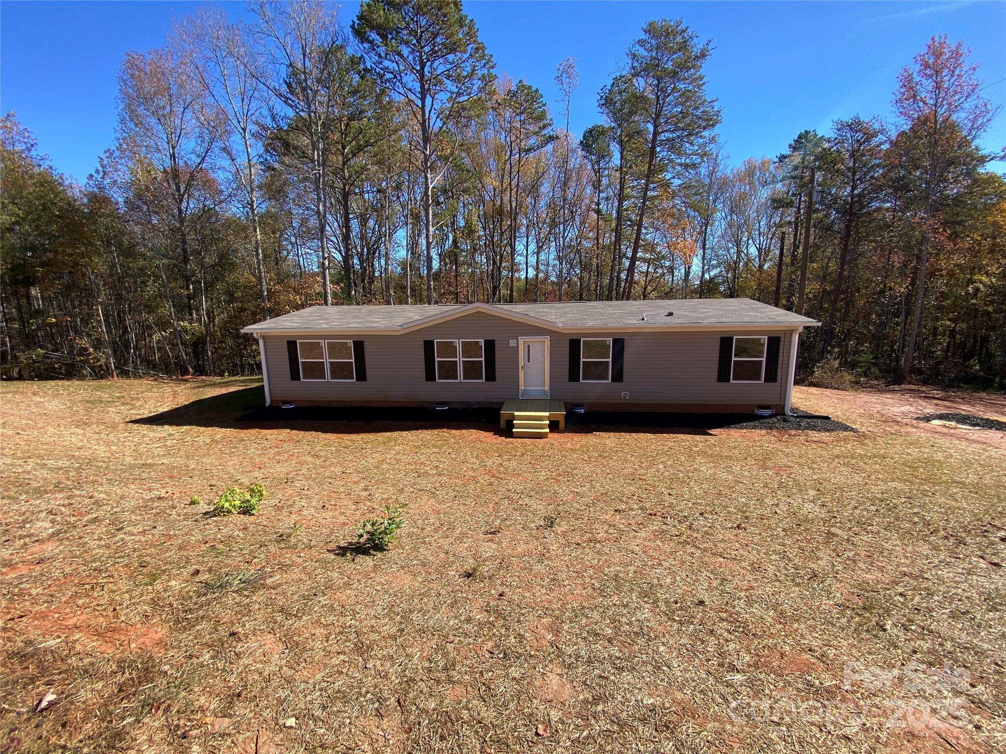 660 Pinehurst Road Ellenboro, NC 28040 - Photo 2 of 29 a view of house with outdoor space and trees in the background