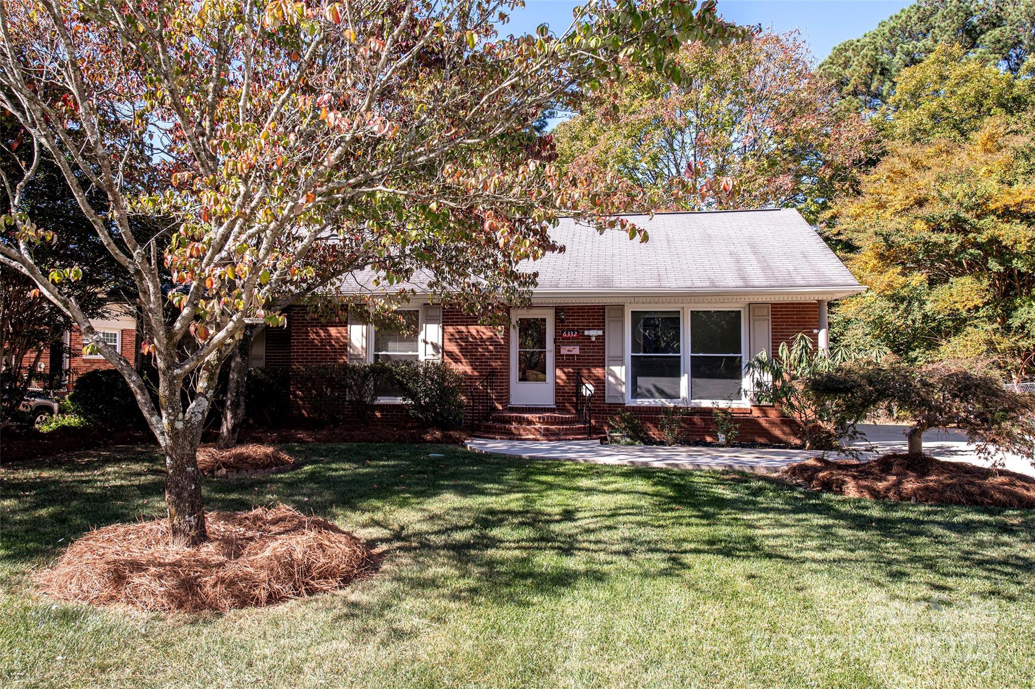 6332 Montpelier Road Charlotte, NC 28210 - Photo 1 of 30 a front view of a house with swimming pool and porch