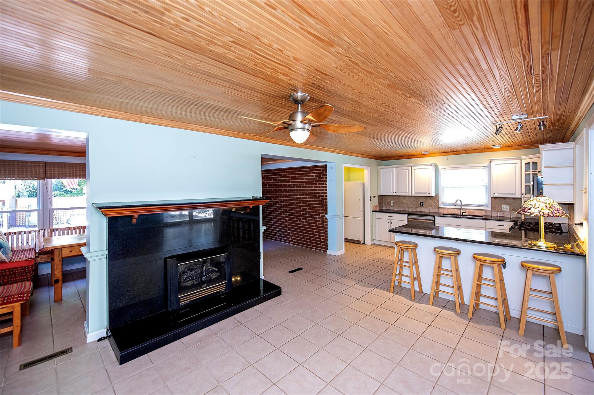 6332 Montpelier Road Charlotte, NC 28210 - Photo 12 of 30 a kitchen with stainless steel appliances kitchen island granite countertop a table chairs and a refrigerator