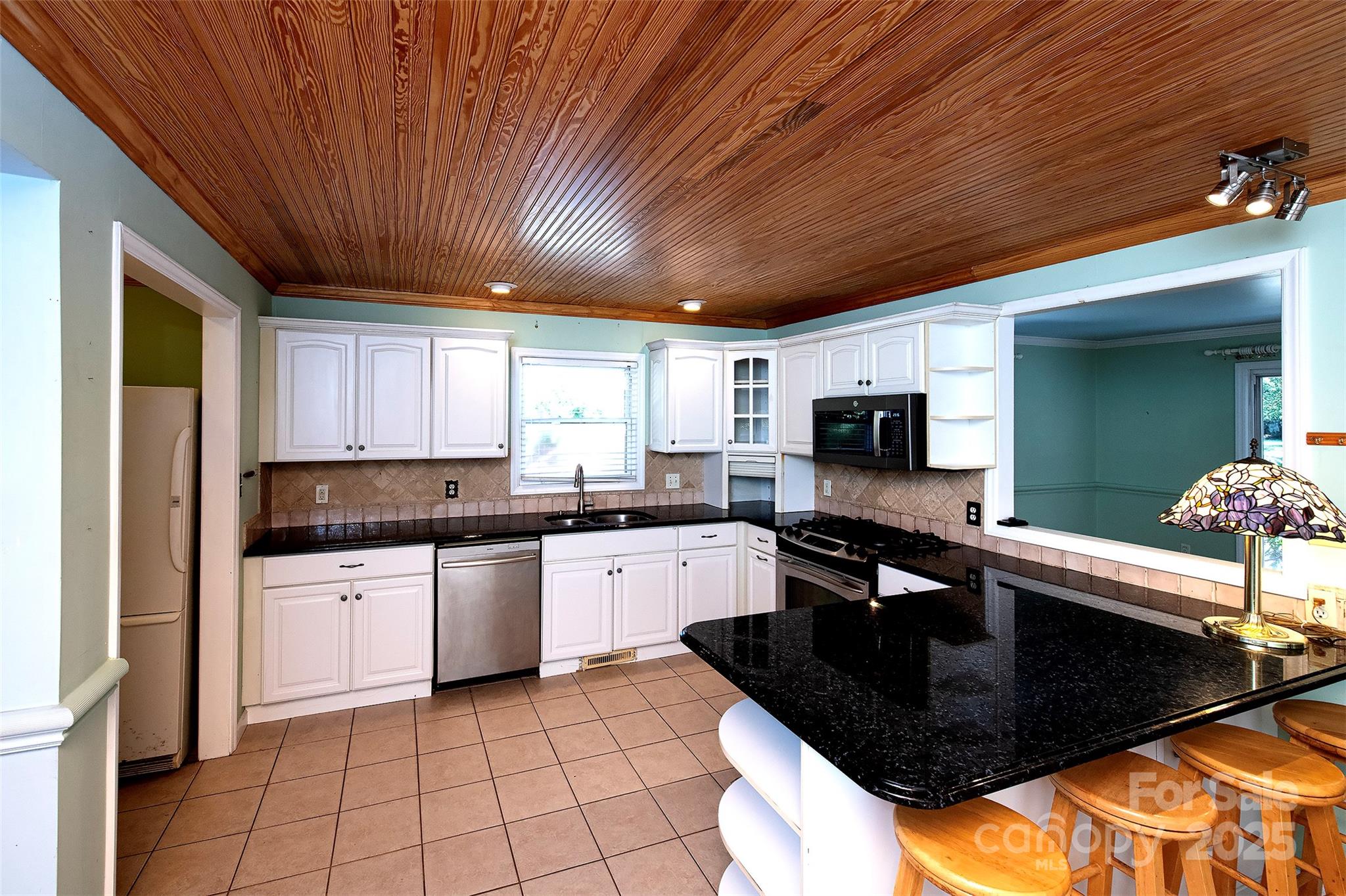 6332 Montpelier Road Charlotte, NC 28210 - Photo 14 of 30 a kitchen with a sink a stove and cabinets