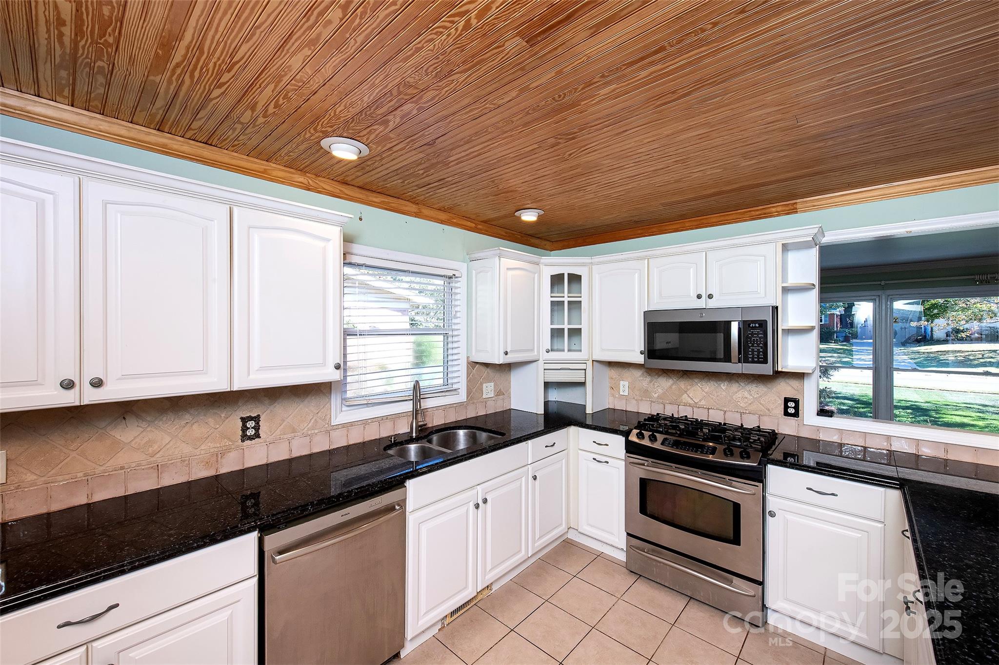 6332 Montpelier Road Charlotte, NC 28210 - Photo 15 of 30 a kitchen with granite countertop a sink cabinets and stainless steel appliances