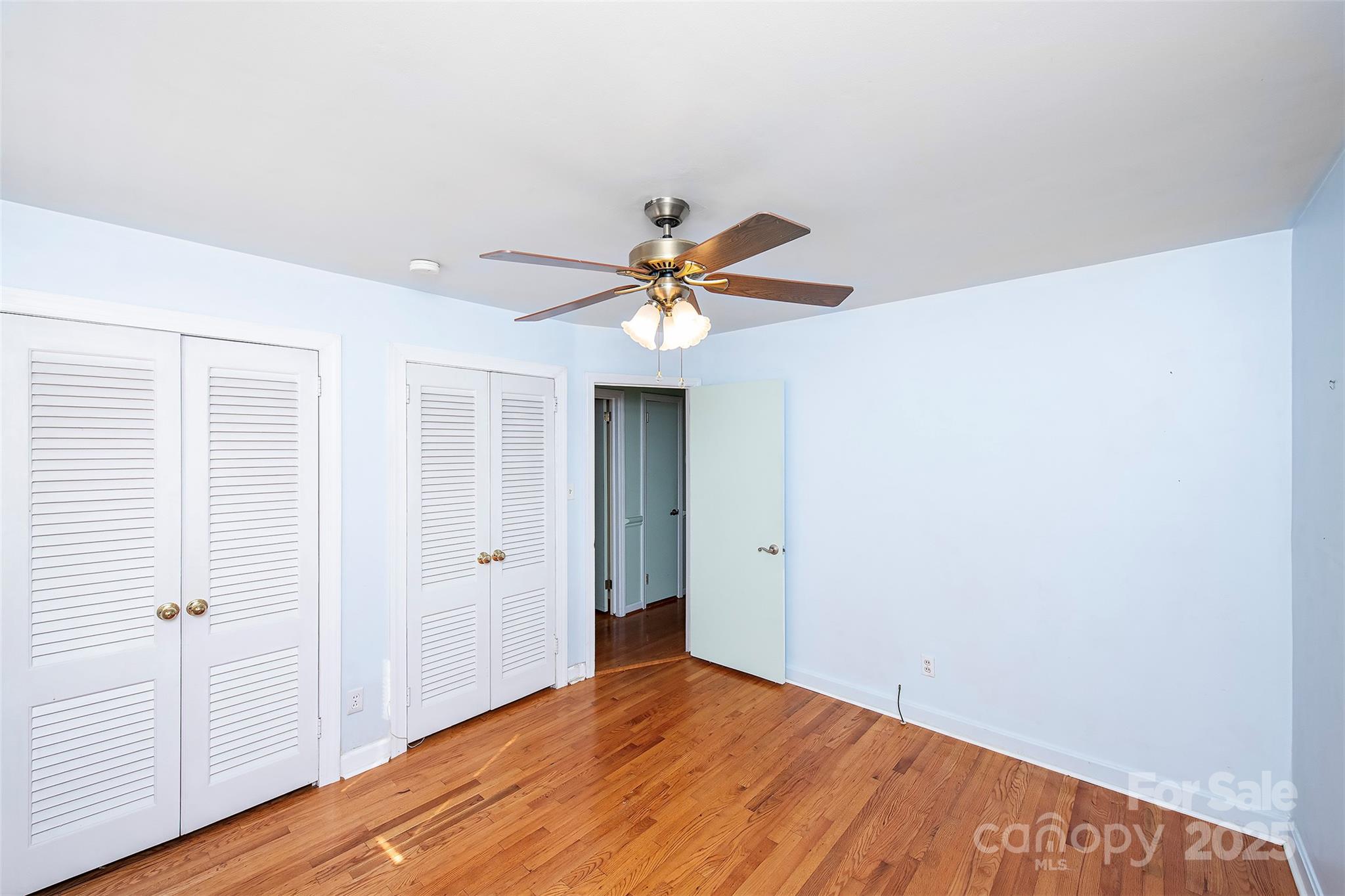 6332 Montpelier Road Charlotte, NC 28210 - Photo 21 of 30 a view of a livingroom with a ceiling fan and wooden floor