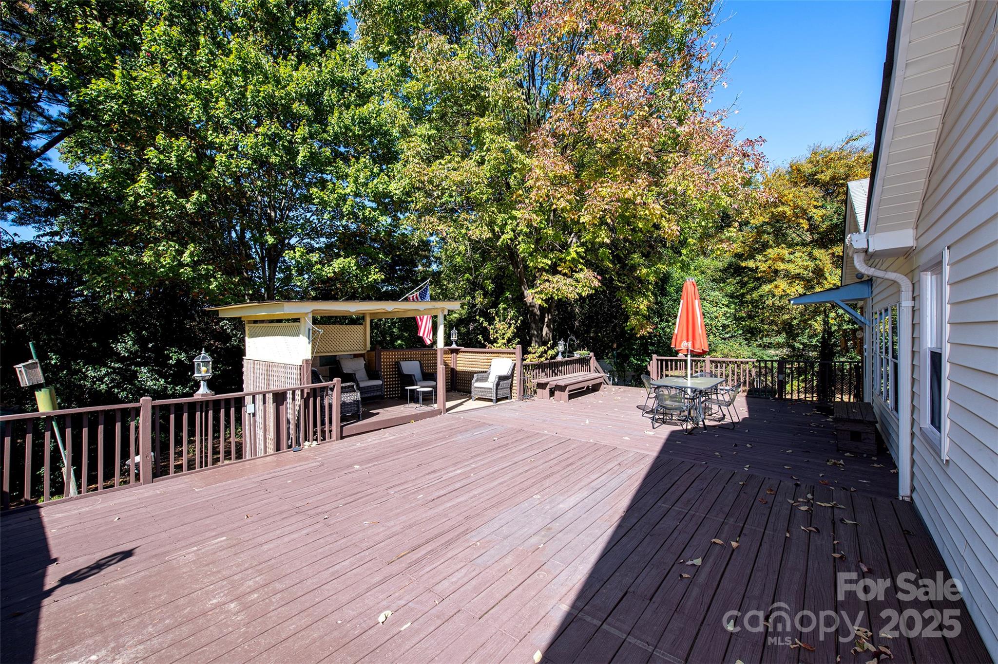 6332 Montpelier Road Charlotte, NC 28210 - Photo 27 of 30 a view of a patio with dining table and chairs with wooden floor and fence