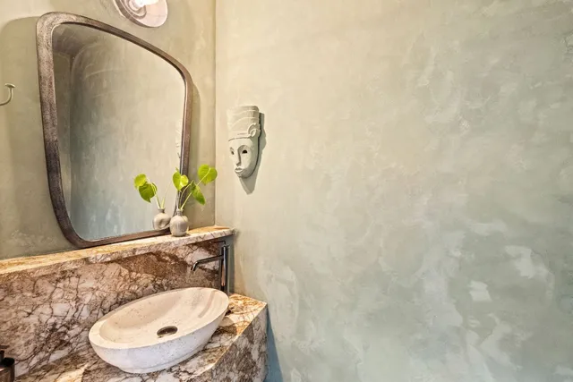a bathroom with a sink mirror and vanity