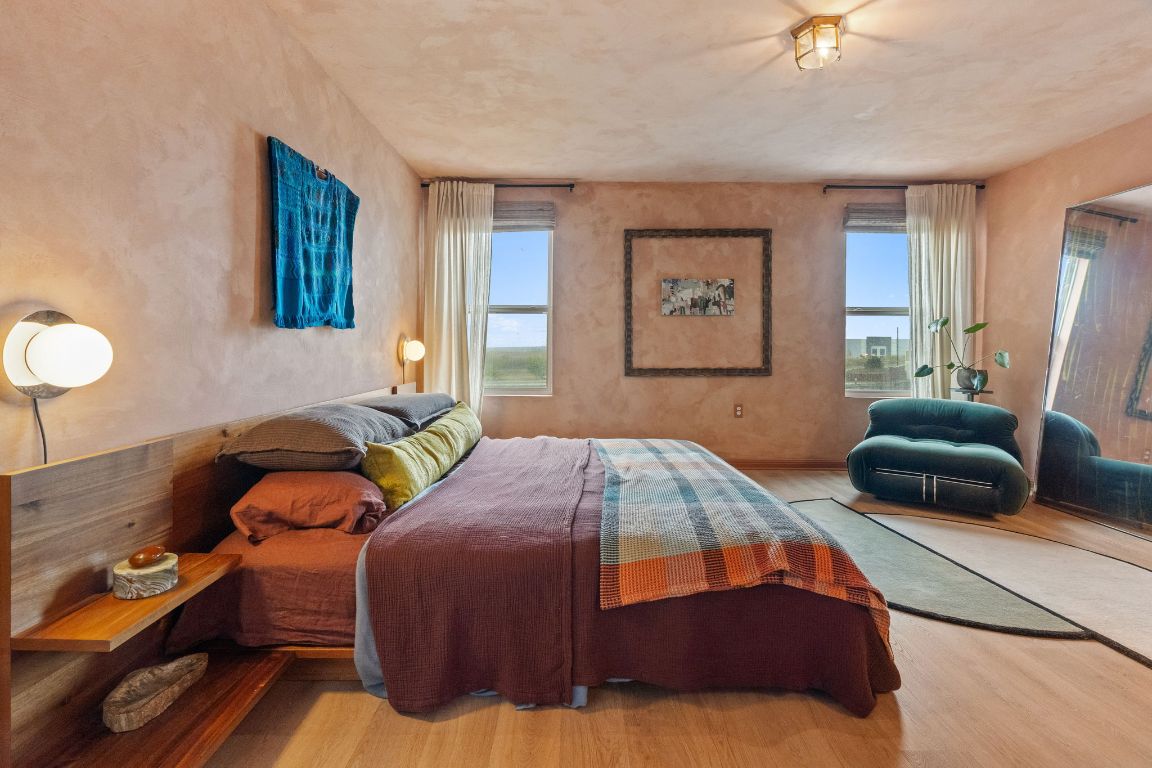 6703 Routenburn Street Austin, TX 78754 - Photo 20 of 34 a bedroom with two beds and a chandelier