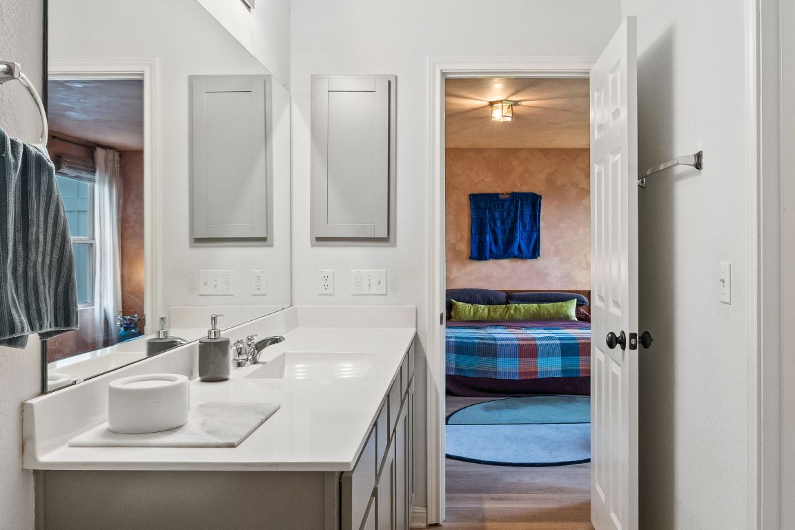 6703 Routenburn Street Austin, TX 78754 - Photo 24 of 34 a bathroom with a sink and a mirror