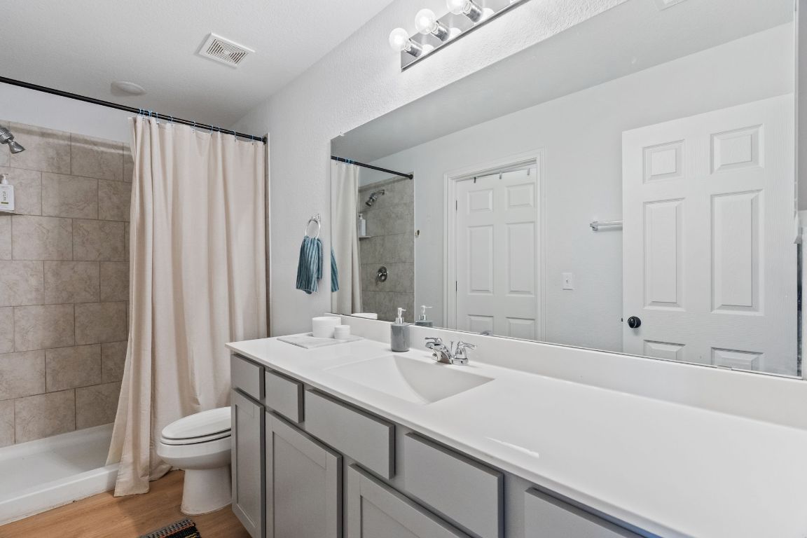 6703 Routenburn Street Austin, TX 78754 - Photo 25 of 34 a bathroom with a sink a toilet and shower