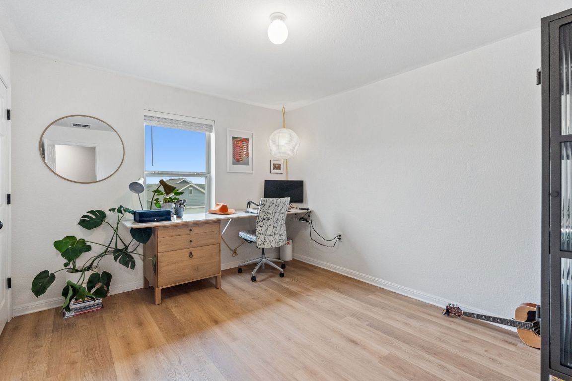 6703 Routenburn Street Austin, TX 78754 - Photo 26 of 34 a living room with furniture and a potted plant