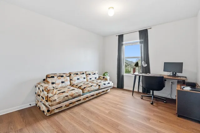 a bed room with a bed and a chair