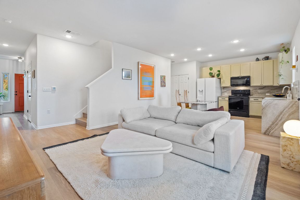 6703 Routenburn Street Austin, TX 78754 - Photo 4 of 34 a living room with furniture and a wooden floor