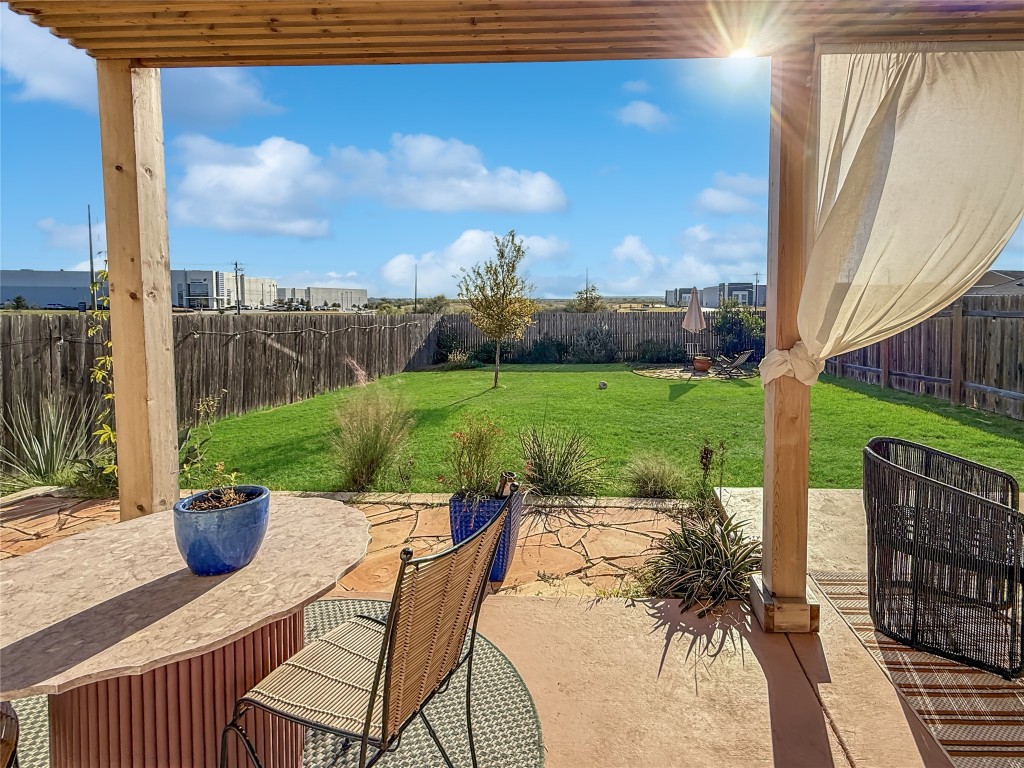 6703 Routenburn Street Austin, TX 78754 - Photo 6 of 34 a view of a patio with a table chairs and a yard