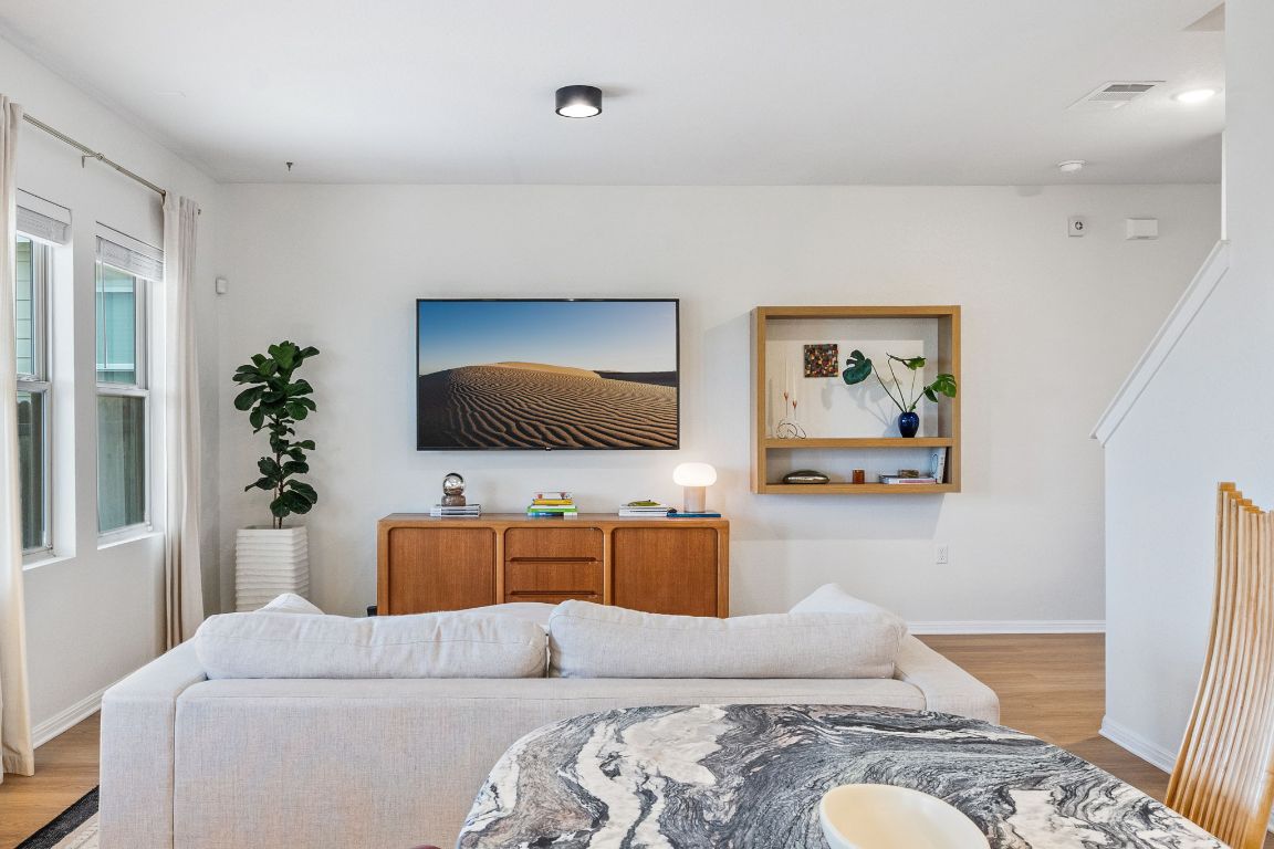 6703 Routenburn Street Austin, TX 78754 - Photo 8 of 34 a living room with furniture and a flat screen tv