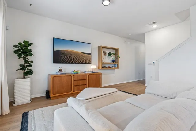 a bedroom with furniture and a flat screen tv