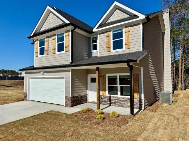 a view of a house with a yard and garage