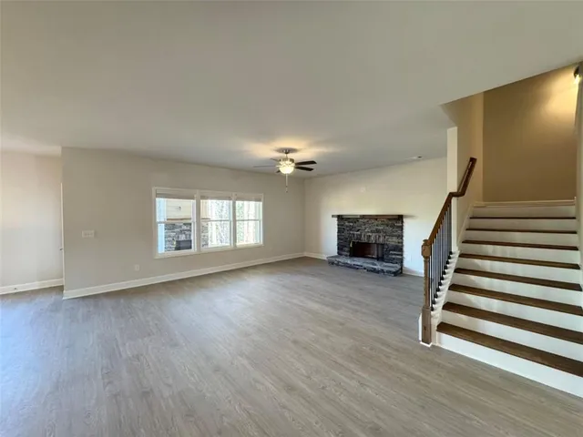 wooden floor in an empty room with a fireplace