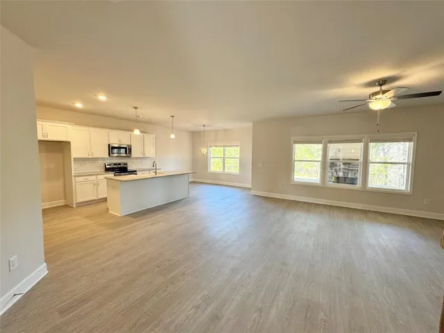 a view of kitchen with wooden floor and window