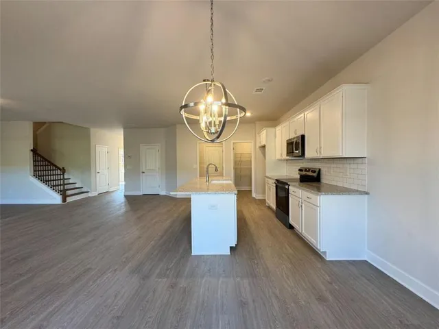 a kitchen with wooden floors and cabinets