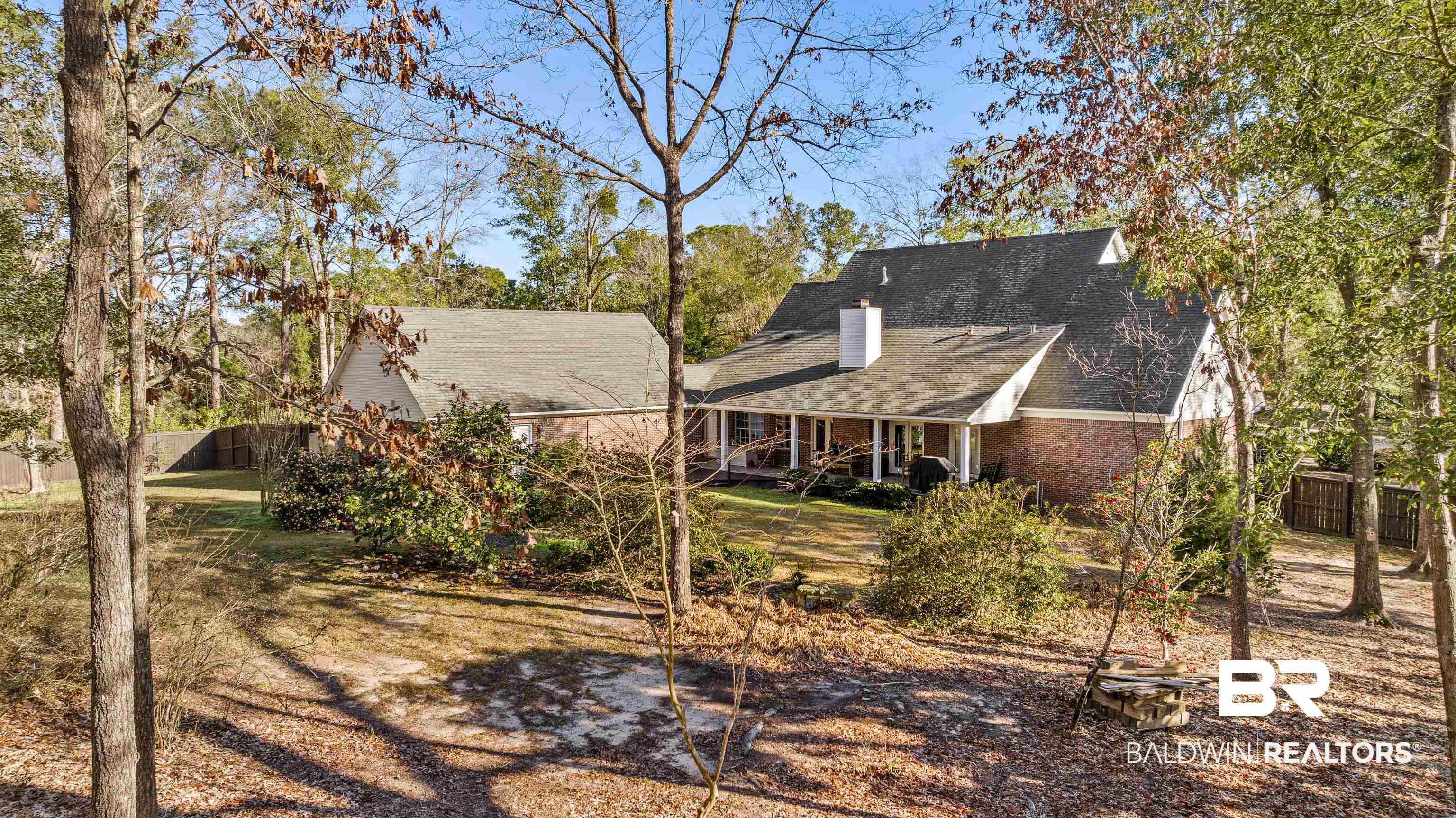 31267 Blakeley Ridge Court Spanish Fort, AL 36527 - Photo 48 of 61 Back of property featuring covered porch, brick siding, fence, and a chimney