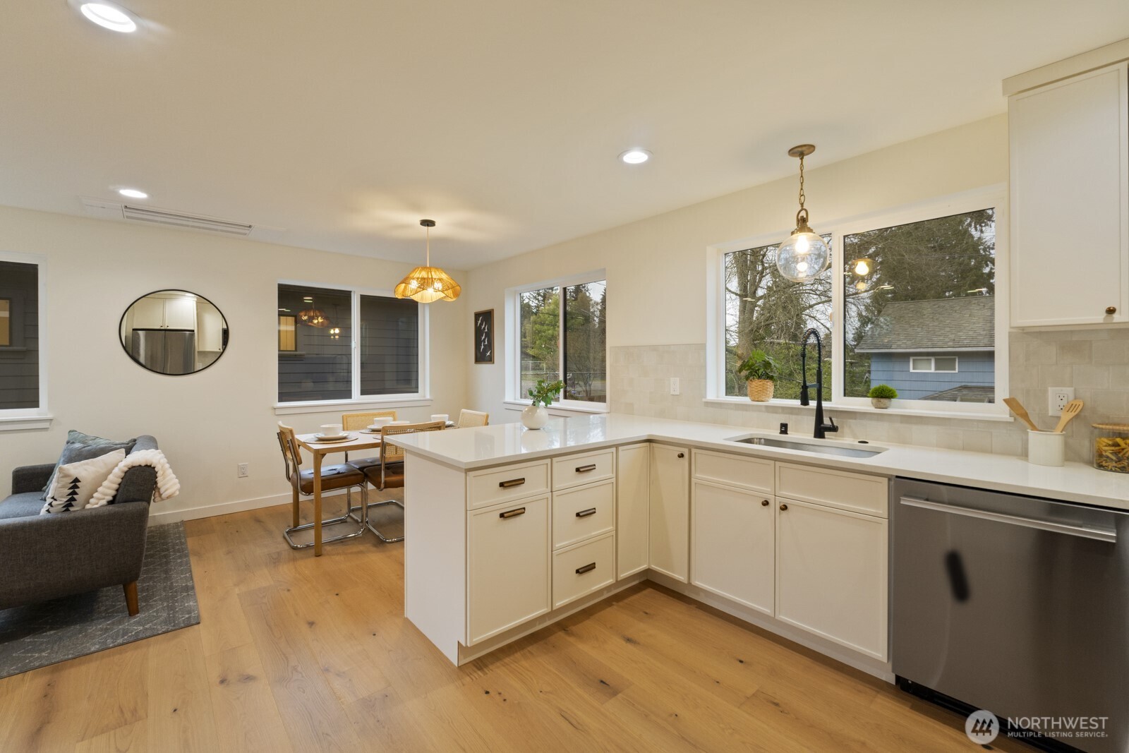 2725 Northeast 87th Street Seattle, WA 98115 - Photo 14 of 30 a large kitchen with kitchen island a sink stainless steel appliances and dining table