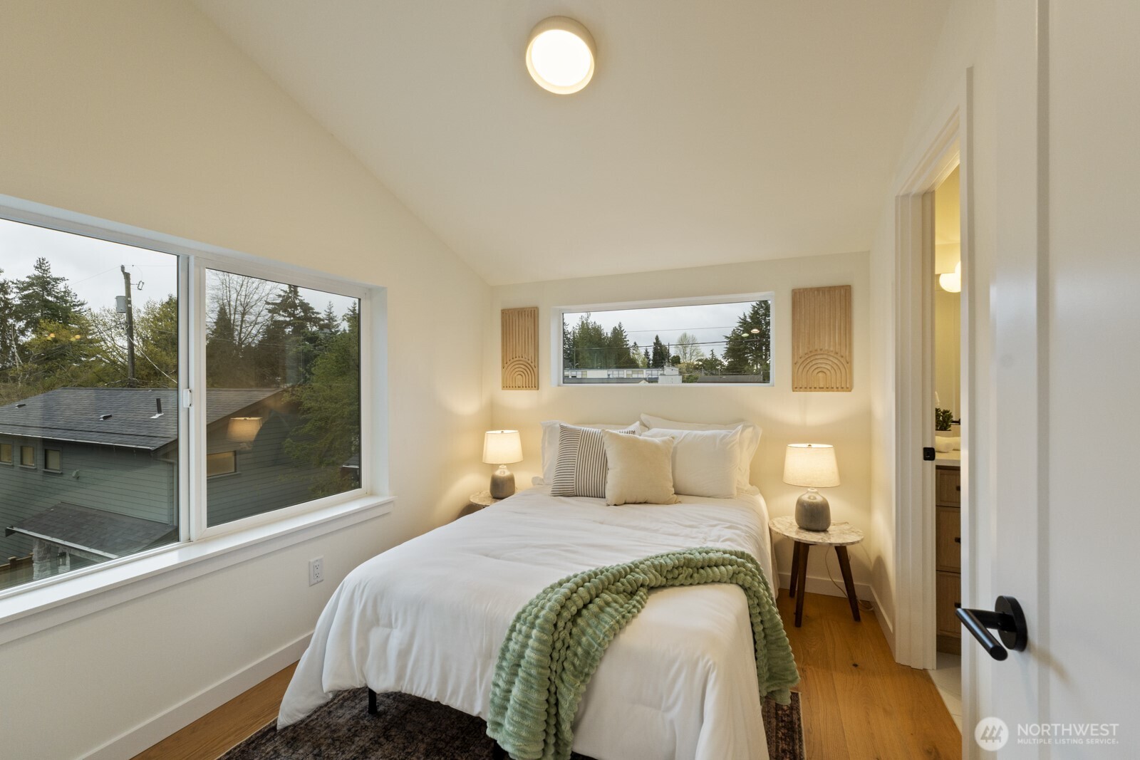 2725 Northeast 87th Street Seattle, WA 98115 - Photo 17 of 30 a bedroom with a bed and wooden floor