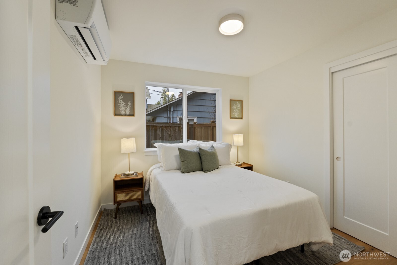 2725 Northeast 87th Street Seattle, WA 98115 - Photo 18 of 30 a bedroom with a bed and a table in it