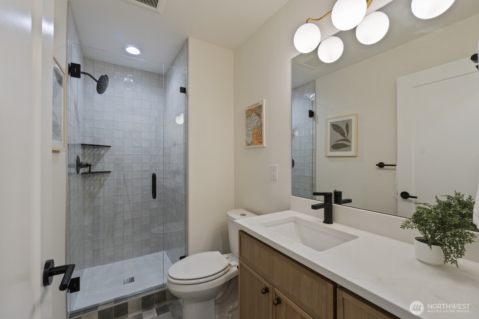 2725 Northeast 87th Street Seattle, WA 98115 - Photo 19 of 30 a bathroom with a sink toilet a mirror and shower