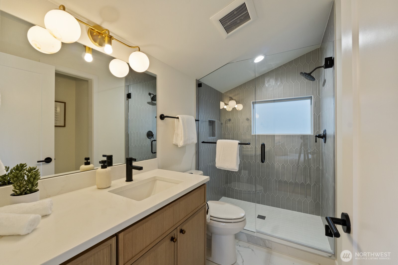 2725 Northeast 87th Street Seattle, WA 98115 - Photo 21 of 30 a bathroom with a sink a toilet and shower