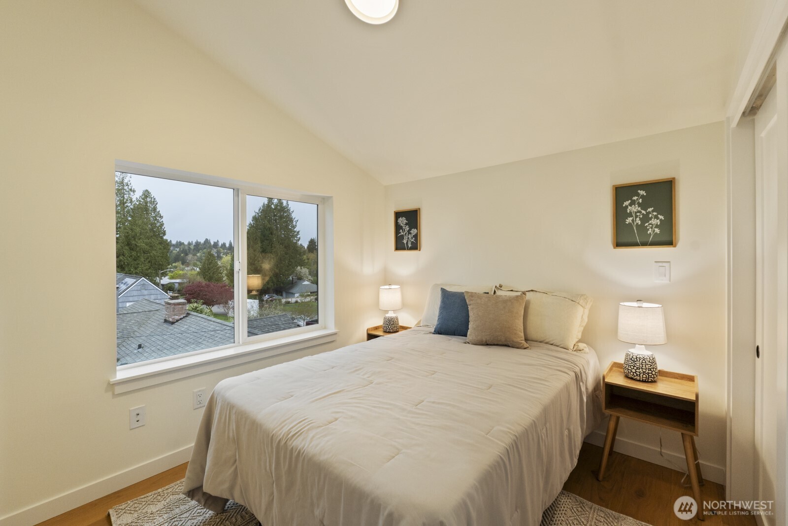 2725 Northeast 87th Street Seattle, WA 98115 - Photo 22 of 30 a bedroom with a bed and a painting on the wall