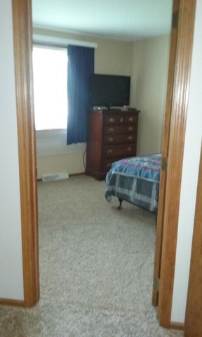 405 Main St Road Spring Grove, IL 60081 - Photo 8 of 10 a room with a chair and a window