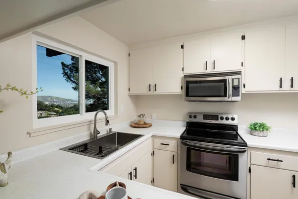 a kitchen with a sink stove and microwave