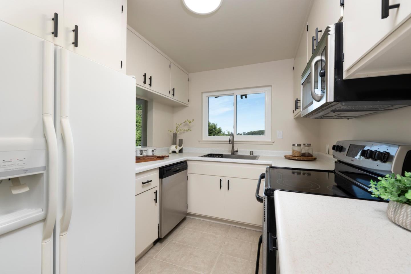 1255 Tuolumne Road Millbrae, CA 94030 - Photo 14 of 42 a kitchen with stainless steel appliances granite countertop a sink and a stove