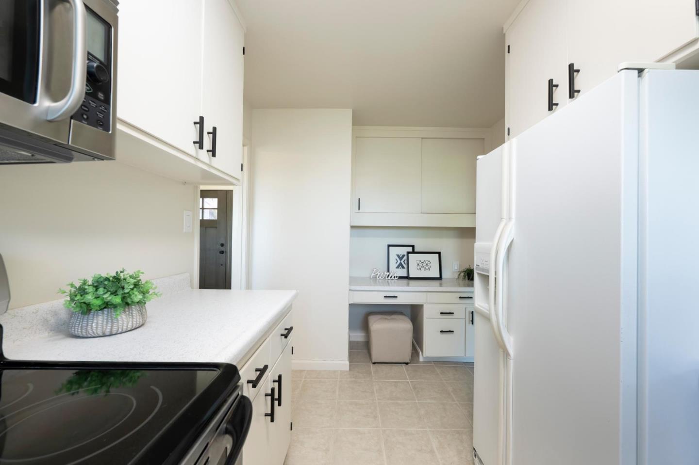1255 Tuolumne Road Millbrae, CA 94030 - Photo 16 of 42 a kitchen with stainless steel appliances a white stove top oven and a refrigerator