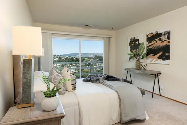 a bedroom with a bed and a potted plant