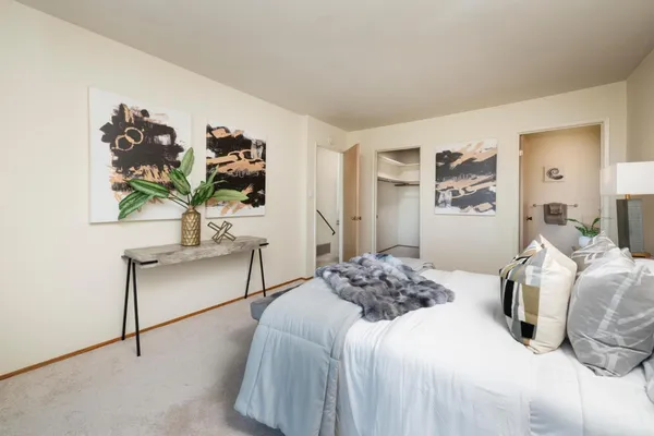 a bedroom with a bed and a painting on the wall