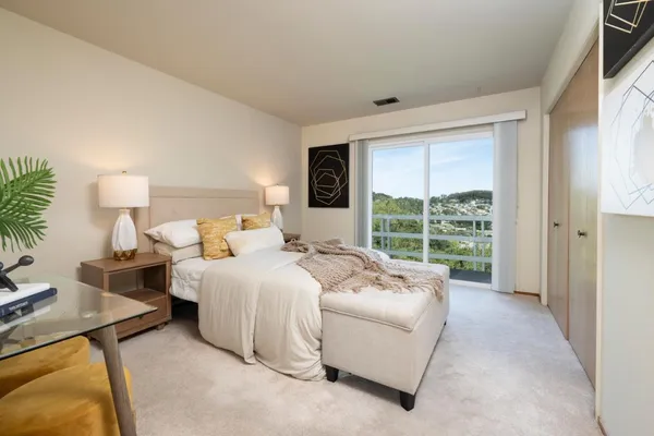 a bed room with bed and a large window
