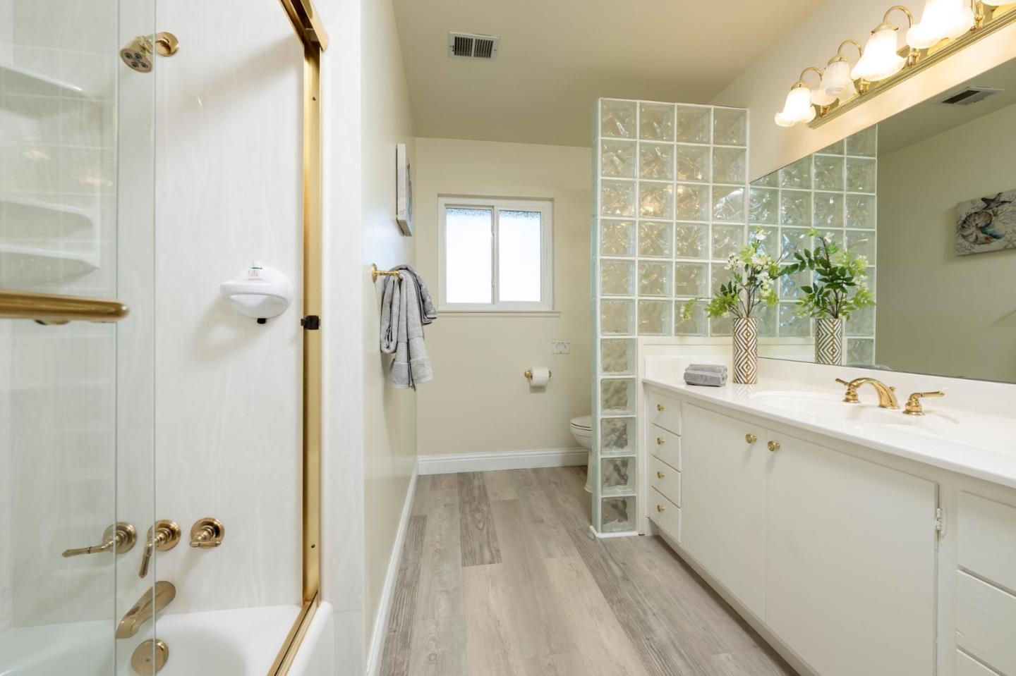 1255 Tuolumne Road Millbrae, CA 94030 - Photo 28 of 42 a bathroom with a tub sink and mirror